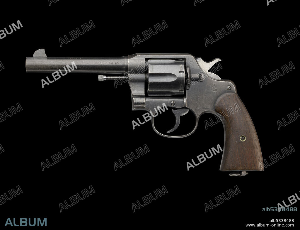 COLT'S PATENT FIRE ARMS MANUFACTURING COMPANY. African-American lawyer Charles Hamilton Houston (1895-1951) graduated from Amherst College and Harvard Law School. He was Dean of Howard University Law School and Litigation Director of the NAACP, and earned the title "The Man Who Killed Jim Crow" for his role in dismantling Jim Crow laws, especially attacking segregation in schools and racial housing covenants. Colt Model 1917 Revolver .45 ACP (Automatic Colt Pistol) No 22-883 issued by the United States Army to Charles Hamilton Houston during World War I. The gun is comprised of metal with wood applied to the handle. The revolver has a six-round cylinder that is semi-removable so bullets can be loaded. There are multiple manufacturer's notes throughout the barrel and frame. On the left of the barrel, text reads [COLT D.A. 45]. On top of the barrel is the manufacture's information, [COLT’S PT FA MFG CO. HARTFORD, CT U.S.A. / PAT’D AUG. 5, 1884 JUNE 6 1900 JULY 4 1905]. On the left side of the frame, at the top next to the hammer are the letters [GHS] in a circle. Below the hammer on the frame is a horse standing on its hind legs with two spears. The bottom of the grip has a circular hinge with a cylinder shaped metal. Surrounding the hinge are the words, [U.S. / ARMY / MODEL / 1917 / N° / 22 / 883].