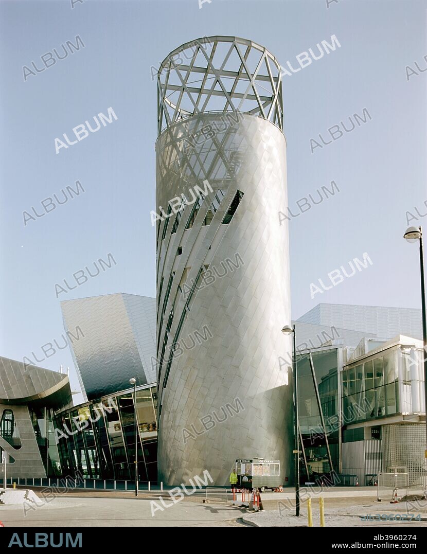 Lowry Centre, Pier 8, Salford Quays, Salford, Manchester, 2000. Named after the Manchester artist LS Lowry, this Millennium project houses two theatres, three art galleries and conference facilities. One gallery is dedicated to Lowry's works. Designed by Michael Wilford & Partners and the late Sir James Stirling, it opened in 2000. An ice cream kiosk is parked at the foot of the tower.
