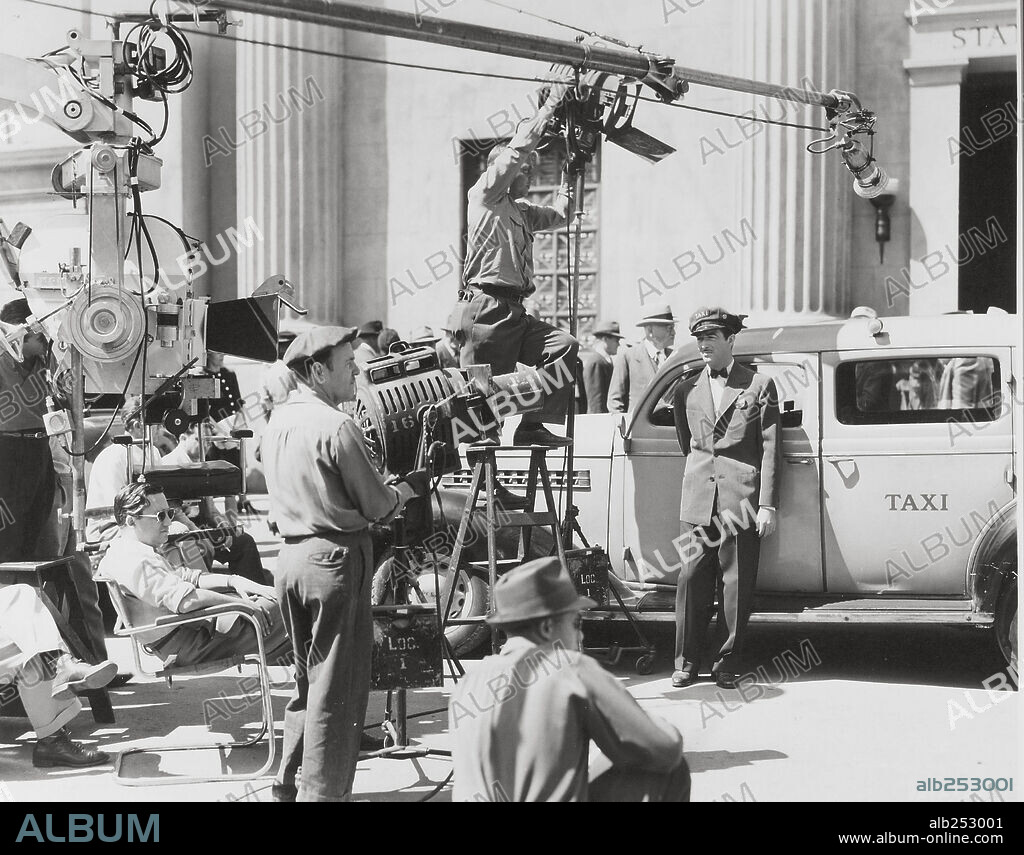 MERVYN LEROY and ROBERT TAYLOR in JOHNNY EAGER, 1942, directed by MERVYN LEROY. Copyright M.G.M.