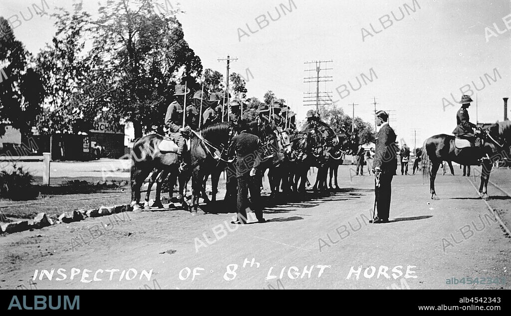 Negative - Lord Huntingfield Inspecting the 8th Light Horse, Wangaratta, Victoria, circa 1935, Row of uniformed soldiers on horses on road, facing two men in suits. One is looking closely at a horse.