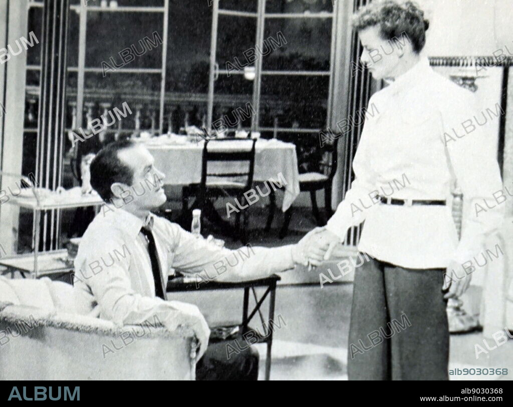 Black and white photo of unidentified man and woman from a film set.