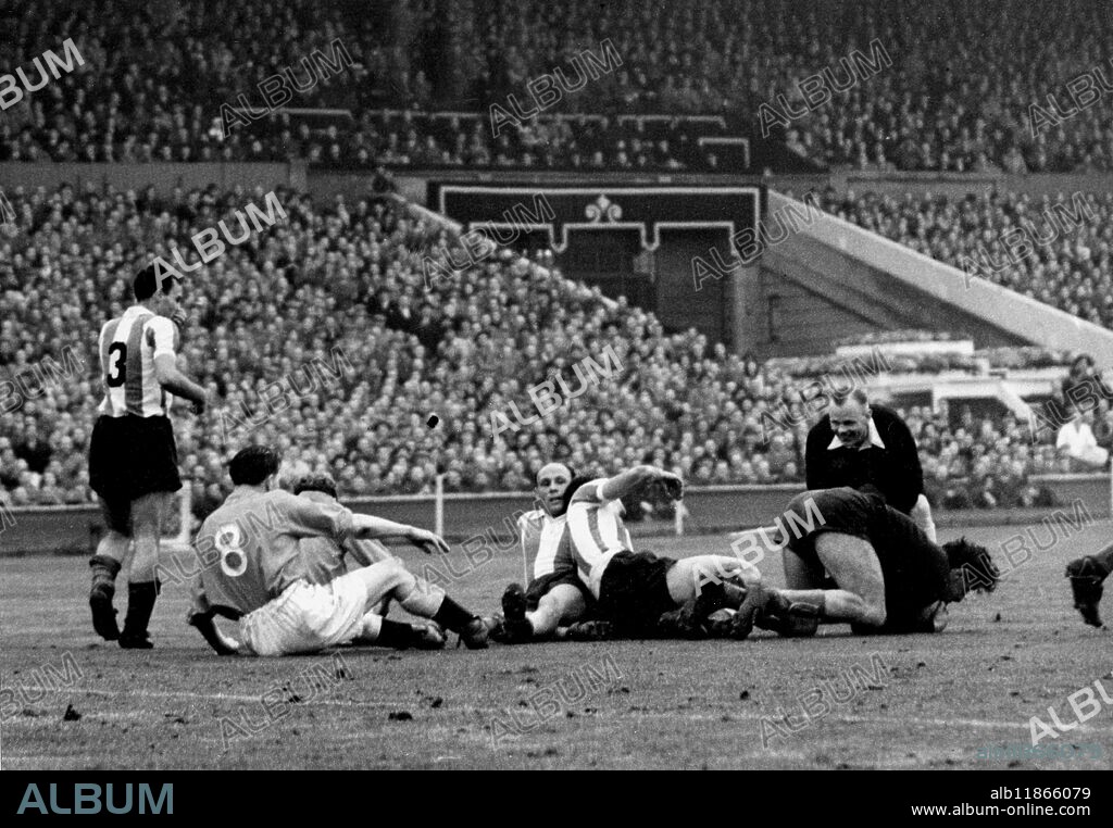 England v Argentina. Argentina goalkeeper Miguel Rugilo gathers the ball from a goalmouth scramble during the international at Wembley Stadium. Extreme left is Argentina left back J.Figueras (No.3) and on the ground is Stanley Mortensen (No.8), the England inside right. 9th May 1951.