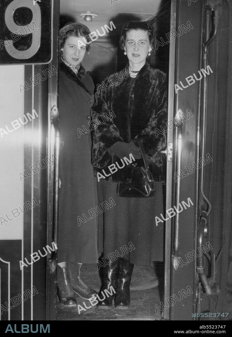 Duchess Sees Daughter Off. To School -- The Duchess  of Kent is seen here with her daughter Princess Alexandra in the doorway of the pullman at Victoria Station, London, to-day, when she saw her daughter off for Paris, where the Princess returns to her finishing school. January 10, 1954. (Photo by Daily Mail Contract Picture).