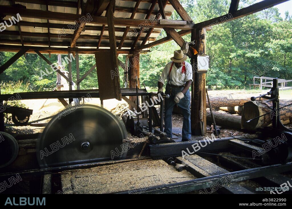 Man operating a sawmill at Agrirama, an historic village and museum of agriculture, in Tifton, Georgia.