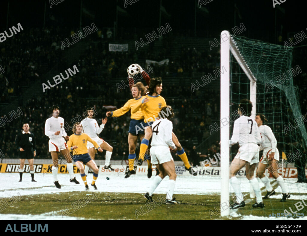 ARKIV 1973-11-27. Svenska fotbollslandslagets Roland Sandberg och Ralf Edström i en luftduell med Österrikes målvakt Herbert Rettensteiner som greppar bollen i den avgörande skiljematchen i VM-kvalet mellan Sverige och Österrike i snöovädret 27:e november 1973 på Folkparkstadion i Gelsenkirchen, Västtyskland. Sverige vann med 2-1 och kvalificerade sig till VM-slutspelet i Västtyskland 1974... Foto: Olle Lindeborg / TT / Kod: 190.