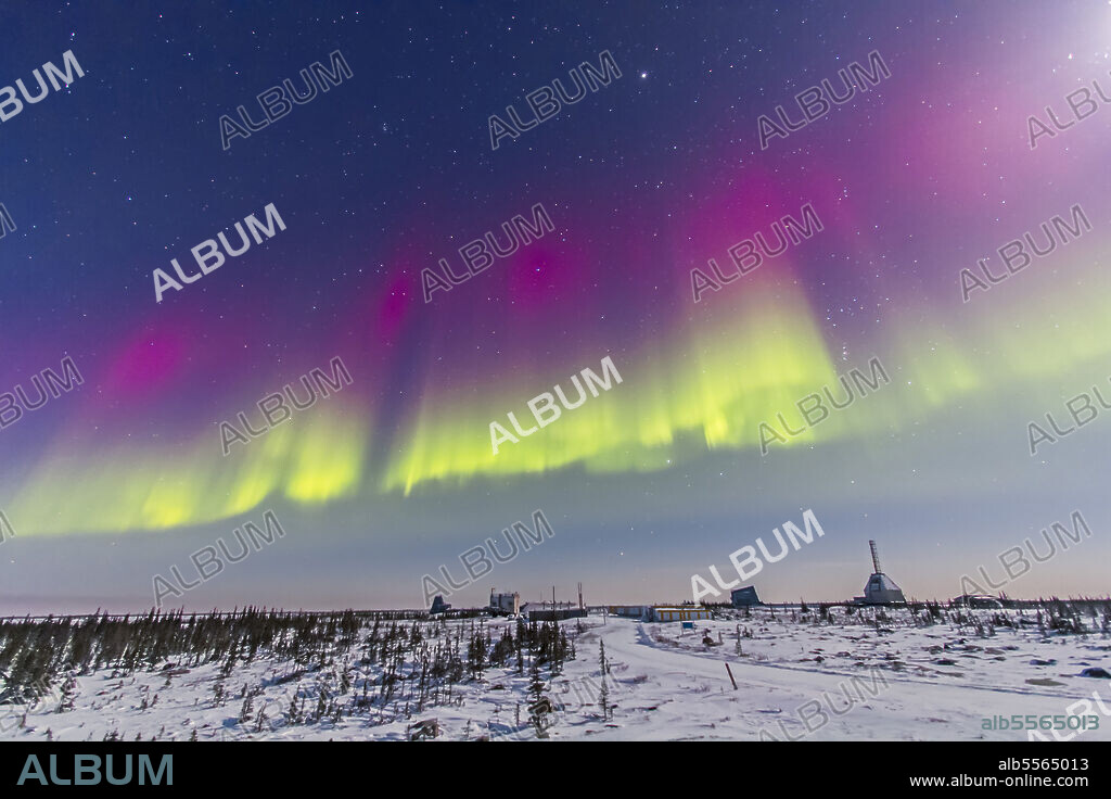 February 7, 2014 - Aurora borealis seen from Churchill, Manitoba, Canada. at the Churchill Northern Studies Centre, in a view looking south over the abandoned Churchill Rocket Range. Jupiter and Gemini are at top and Orion at lower right. The gibbous Moon is just off the frame at upper right.