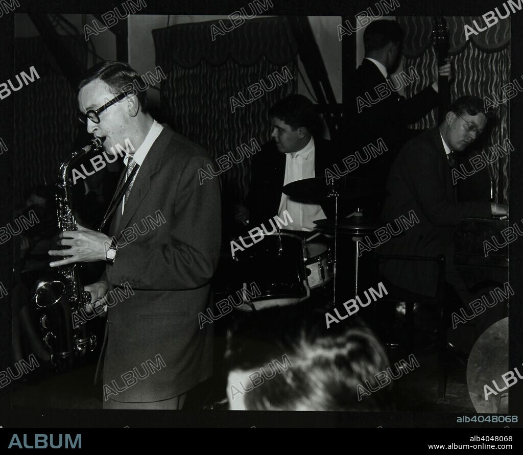 The John Cox Trio and Derek Humble playing at the Civic Restaurant, Bristol, 1955. Humble on alto saxophone, John 'Kloop' Cox on drums and Alan Hurley on the piano. The bassist is unknown.