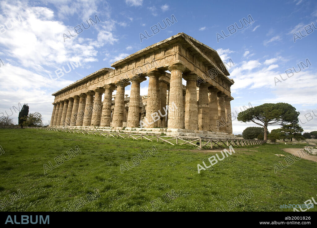 The best preserved of the temples of Magna Graecia is the Temple 'of Neptune' at Paestum (Greek Poseidonia), so called because it seemed logical that the most imposing temple in the city had been dedicated to the god for whom the city was dedicated - Poseidon (Neptune). Today the temple is thought to have been dedicated to Apollo, Zeus or Hera, and it is also known by the name "Temple of Hera II" (or "Second Temple of Hera"). The temple is a Doric hexastyle peripteros, with 6 columns in the facades and 14 columns on each of the sides. It has a raised cella (shrine) flanked by distyle in Antis porticoes and approached by steps. The temple also stands on a stepped crepidoma with three steps. The temple probably dates from between 474 and 450 BC. Thanks to its near-perfect state of preservation it is considered an ideal model of the Doric temple of the Classical period. The archaeological site of Paestum is included in the Cilento and Vallo di Diano National Park, that was declared a World Heritage Site by UNESCO in 1998.