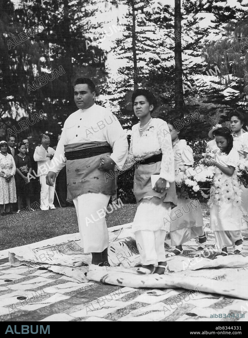 Tongan Wedding. Prince Fatafehi Tui Pelehake and his Maori bride, Princess Melenaite Tupoumoheofo, leaving the Royal Chapel after the church ceremony in Tonga. Queen Salote, who is 6ft. 3min. tall, led her two sons from the Palace to the Chapel. June 20, 1947.