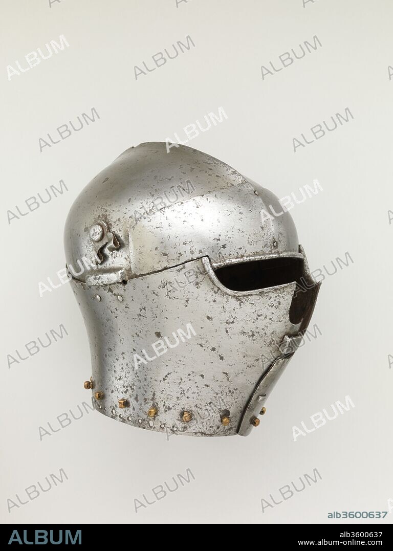 Armet. Culture: Italian. Dimensions: H. 10 in. (25.4 cm); W. 8 in. (20.3 cm); D. 10 15/16 in. (27.8 cm); Wt. 9 lb. 7 oz. (4288 g). Date: ca. 1430-40.
In Italy from 1410 to 1510, the armet was the standard helmet for cavalry. This rare early example has flanges to protect the hinges of the cheekpieces and a staple at the front where a visor was secured.