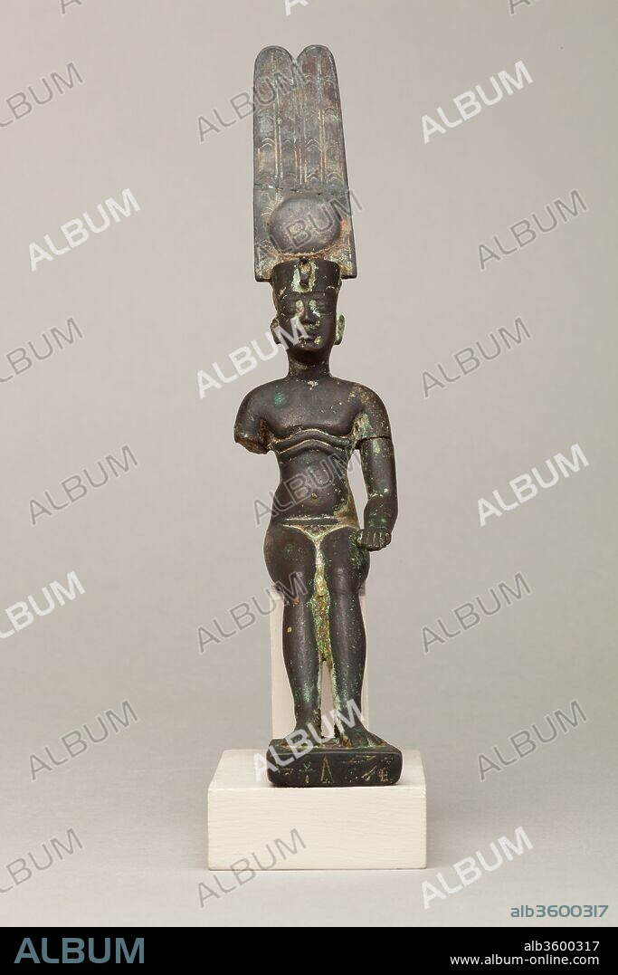 Child god wearing Amonian crown and named Horus of Mednit (Aphroditopolis). Dimensions: H. 18.3 cm (7 3/16 in.); W. 4 cm (1 9/16 in.); D. 11.1 cm (4 3/8 in.). Date: 664-30 B.C..
The figure represents a child god in a seated/reclining position, wearing the double feather crown, which associates him with the god Amun. The child god is usually distinguished from adult gods by a range of iconographic clues: his nudity, the finger raised to the mouth (a child-like gesture), and a sidelock on the right side of his head. The right arm of this figure is broken, and thus the position of the hand is unknown; likely it was held at his mouth or at his side, like the left arm. The sidelock also is not in evidence, but his nudity suffices for identification as a child god. Below his pectorals, the child god has two stylized fat rolls, a feature that is very uncommon on these types of statuettes. Nevertheless, many child gods are shown with rounded or chubby bellies, showcasing the god's ability to bring about prosperity and abundance; these fat rolls express the same ideas.
Child gods grew in popularity and cult from the Third Intermediate Period onwards, rivaling even the most powerful and ancient gods, especially as temple offerings. Because of their profusion and many local forms, generally it is very difficult to assign precise identities to child gods, but an inscription on the base names this figure as Horus of Mednit.