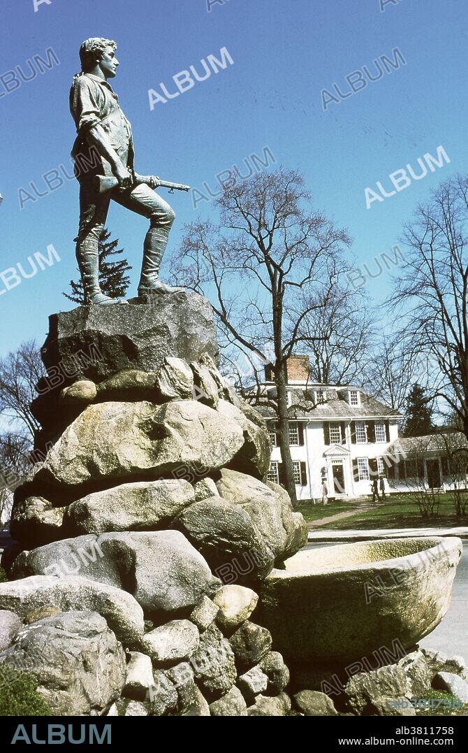 Minuteman statue and the Buckman Tavern, the former headquarters of the minutemen, in Lexington, Massachusetts. A minuteman was a man armed and ready to fight on a minute's notice in the time both leading up to and during the American Revolution.