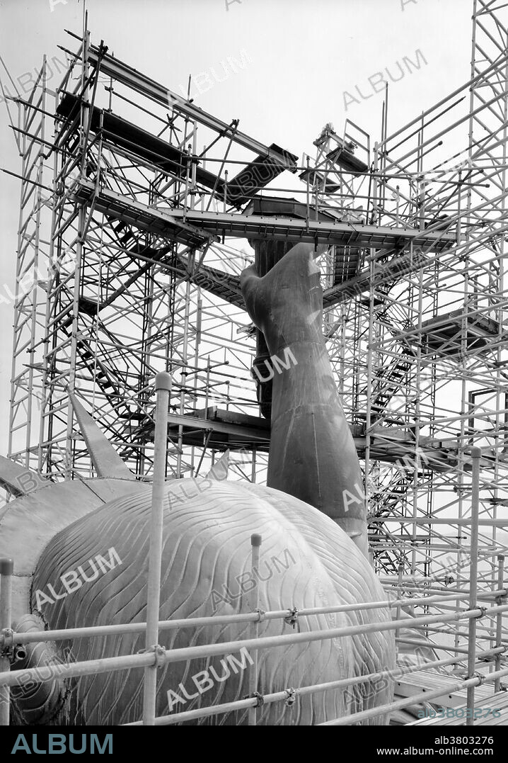 Entitled: "View looking southeast showing back of head and torch arm after flame has been removed, March 1985." The Statue of Liberty is a colossal neoclassical sculpture on Liberty Island in New York Harbor, designed by FrÃ©dÃ©ric Bartholdi and dedicated on October 28, 1886. The statue, a gift to the United States from the people of France, is of a robed female figure representing Libertas, the Roman goddess of freedom, who bears a torch and a tabula ansata (a tablet evoking the law) upon which is inscribed the date of the American Declaration of Independence, July 4, 1776. A broken chain lies at her feet. The statue is 151 feet and 1 inch high, and the top of the torch is at an elevation of 305 feet 1 inch from mean low-water mark. It was the largest work of its kind that had ever been completed up to that time, and was the tallest structure in New York City until the Empire State building topped it in 1929. The statue is an icon of freedom and of the United States: a welcoming signal to immigrants arriving from abroad. In the early 1980s, it was found to have deteriorated to such an extent that a major restoration was required. While the statue was closed from 1984 to 1986, the torch and a large part of the internal structure were replaced. Historic American Engineering Record.