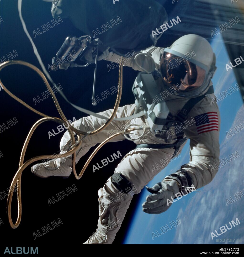Astronaut Edward H. White II, pilot on the Gemini-Titan 4 spaceflight, is shown during his egress from the spacecraft. His face is covered by a shaded visor to protect him from the unfiltered rays of the sun. White became the first American astronaut to walk in space. He remained outside the spacecraft for 21 minutes during the third revolution of the Gemini-4 mission. He wears a specially designed spacesuit for the extravehicular activity (EVA). In his right hand, he carries a Hand-Held Self-Maneuvering Unit (HHSMU) with which he controlled his movements while in space. He was attached to the spacecraft by a 25 feet umbilical line and a 23 feet tether line, both wrapped together with gold tape to form one cord. He wears an emergency oxygen supply chest pack. Astronaut James A. McDivitt is command pilot for the Gemini-4 mission.
