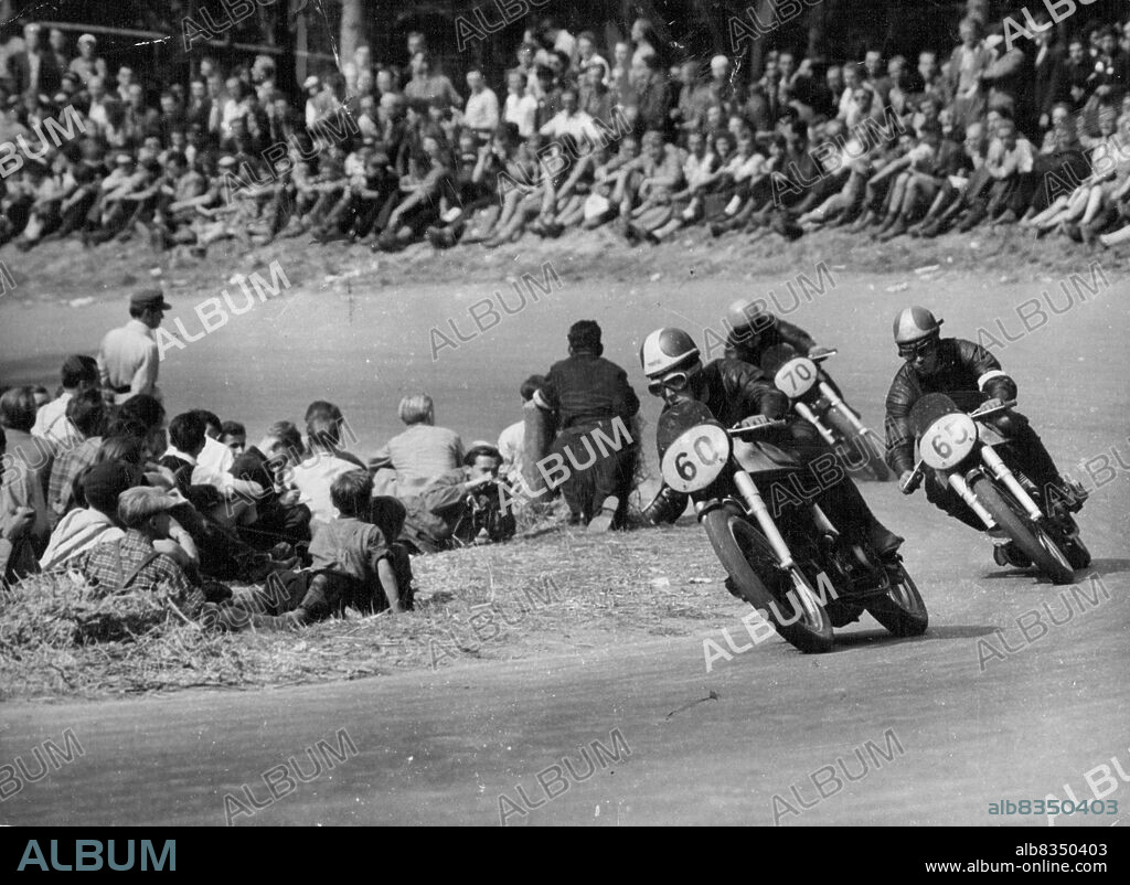 Duke wins in Germany - In the 350 cc event Geoffrey Duke (60) leads Johnny Lockett (65), of Britain who was second, and Ken Kavanagh of Australia (70) who was third. All are driving British Norton machines.British Geoffrey Duke set two new track records at the ***** race course near Stuttgart, August 26, when he won both the major events of the German motor-cycle Grand Prix. He won the 500 cc event at an average of 136 kmph (about 84.5 mph) and the 350 cc event at 130.6 kmph (about 81 mph). September 8, 1951.