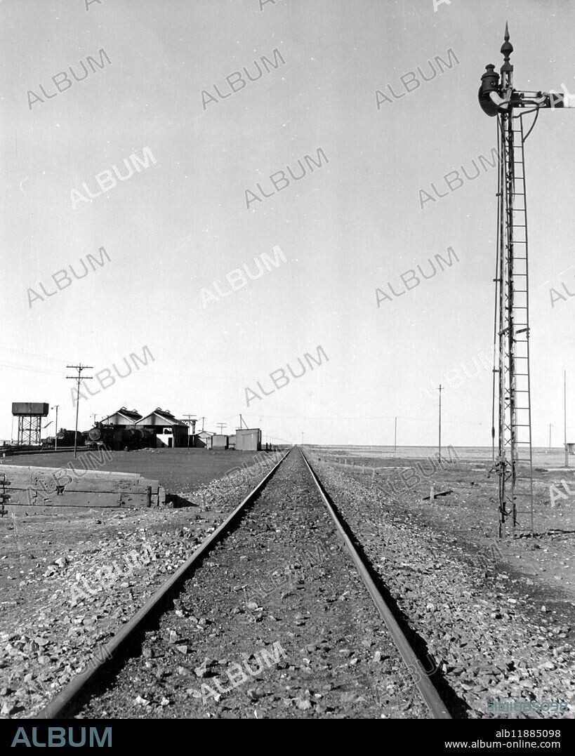 For four hundred miles the Trans Australian Railway runs the Nullarbor Plain . For three hundred miles of this the line stretches straight ahead without a single curve - the longest stretch of straight railway track in the world .