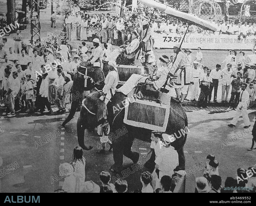 Two Vietnamese women on elephant back represent the celebrated Trung Sisters (Hai Ba Trung) in the annual Hai Ba Trung Parade, Saigon, 26 April 1957. The Trung Sisters (c. 12 - 43 CE), known in Vietnamese as Hai Bà Trung (literally 'the two Trung Ladies'), and individually as Trung Tr?c and Trung Nh?, were two first century Vietnamese women leaders who successfully rebelled against Chinese Han-Dynasty rule for three years, and are regarded as national heroines of Vietnam. The sisters were born in Northern Vietnam, the dates of their birth are unknown, but Trung Tr?c was older than Trung Nh?. The exact date of their death is also unknown but both died in 43 CE.