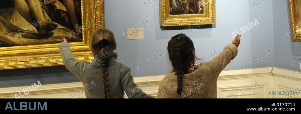 Girls looking at a painting. The State Hermitage Museum. Saint Petersburg. Russia.