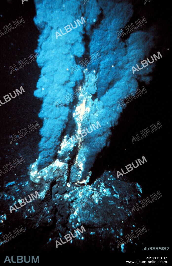 Black smoker hydrothermal vent. Black smokers are found on the deep ocean floor. Hot magma (molten rock) below the surface heats water in the rock, which then erupts from the seabed into the water. Despite being at temperatures of several hundred degrees Celsius, the water does not boil due to the immense pressure at that depth. When it contacts the surrounding cold water it cools rapidly and dissolved minerals precipitate from it, which are responsible for the characteristic black color of the water jets. Many black smokers support ecosystems based on bacteria that can utilize the dissolved minerals. These are one of the few ecosystems on Earth not directly dependent on the Sun's energy. Photographed in the Atlantic Ocean.