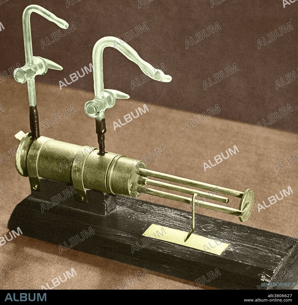 Color enhanced photograph of the apparatus with which Earnest Rutherford first observed artificial transmutation in 1919. In this equipment, nitrogen atoms were converted into oxygen atoms, when in collision with alpha particles from a source in inside the horizontal enclosed tube. Protons ejected by nitrogen when forming oxygen were detected at the rectangular window at the end of the tube.