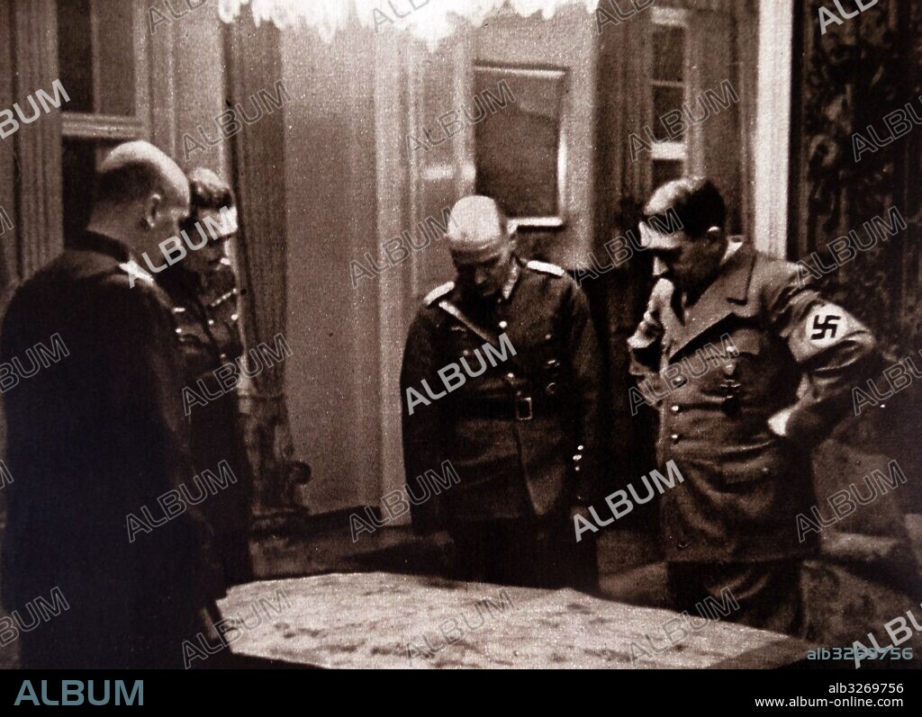 Adolf Hitler (1889-1945) a German politician who was the leader of the Nazi Party, Chancellor of Germany, and Fuhrer of Nazi Germany, and his generals, looking at a map of former Czechoslovakia. Dated 20th Century.