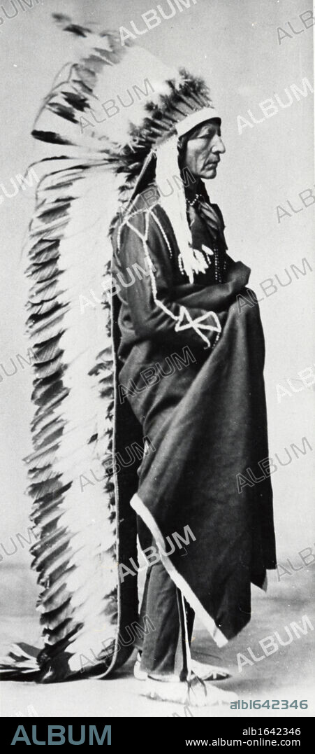 Standing Bear, Chief of the Sioux, wearing ceremonial robes and full length head-dress of eagle feathers: Dakota, North American Plains Indians. Photograph c1885-1890.