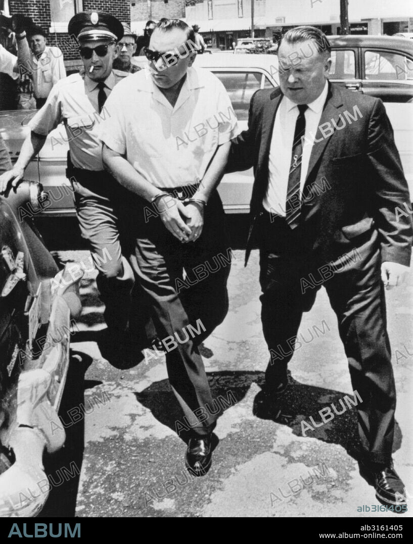 Ripley, Mississippi: June 14, 1966 Handcuffed Aubrey James Norvall is escorted by the Desoto County sheriff back to jail after a Mississippi circuit judge refused to lower his bail for the ambush shooting of civil rights leader James Meredith.