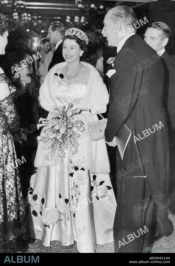 The Queen At Film Premiere. H.M. Queen Elizabeth wearing a beautiful evening dress of white satin embroidered with sprays of roses, greeted on arrival. H.M. The Queen with the Duke of Edinburgh attended the Premiere of the new file "Richard III" at the Leicester Square Theatre, London. The film stars Sir Laurence Olivier and Claire Bloom. December 14, 1955. (Photo by Sport & General Press Agency, Limited).
