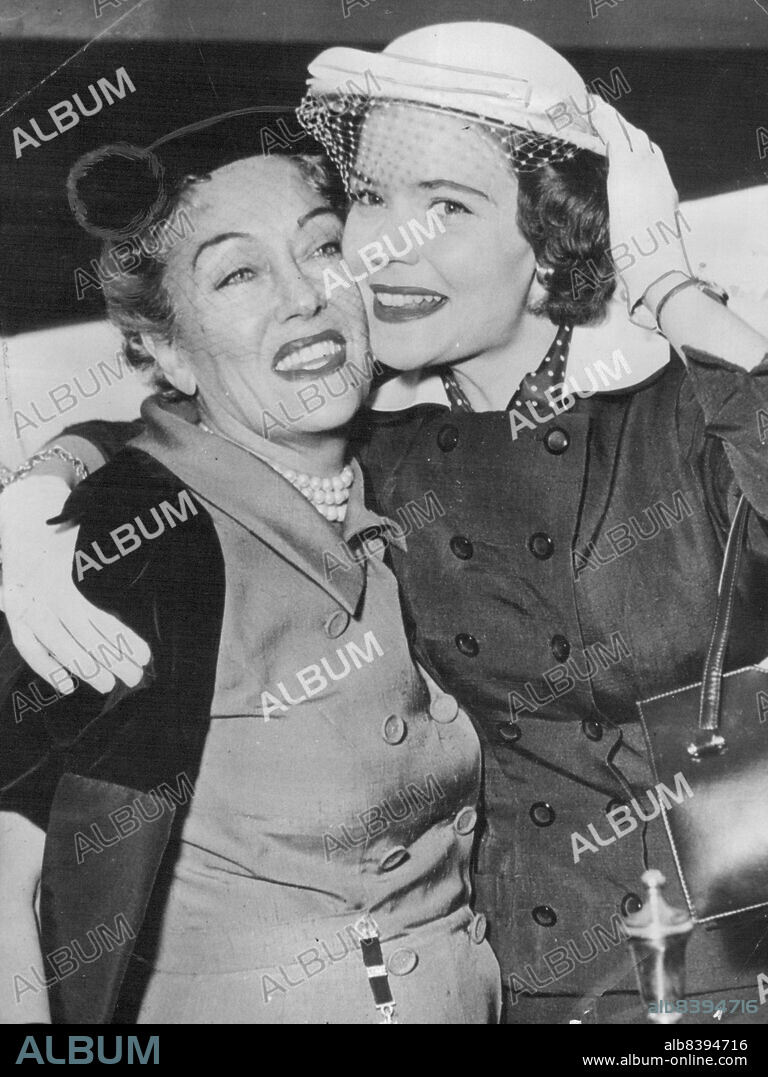 Gloria Swanson In Paris - American actress Gloria Swanson is greeted by her daughter, Michele Farmer, on her arrival at Orly Airport, Paris. June 14, 1954.