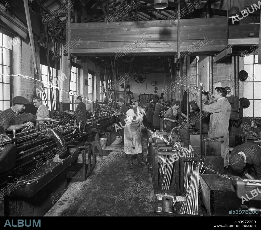 The Birmingham Small Arms factory, Small Heath, Birmingham, February 1917. Interior of the barrel shop showing workers finishing gun barrels during the First World War. One of series of photographs of the BSA factory which produced rifles, Lewis guns, shells and military vehicles.
