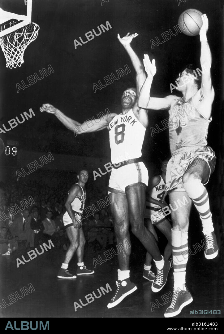 New York, New York: April 8, 1953 Minneapolis Laker George Mikan shoots a hook shot over NY Knickerbocker Nat Clifton in the NBA Championship series.