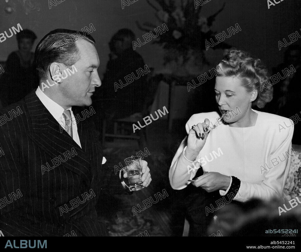 George Sanders & Producer-writer Joan Harrison at recent cocktail party ***** by Universal Studios. She was once Secretary & Alfred Hitchcock. January 01, 1945.