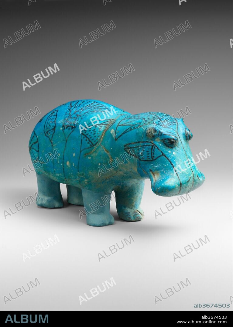 Hippopotamus ("William"). Dimensions: L. 20 cm (7 7/8 in.); W. 7.5 cm (2 15/16 in.); H. 11.2 cm (4 7/16 in.). Dynasty: Dynasty 12. Reign: Senwosret I to Senwosret II. Date: ca. 1961-1878 B.C..
This well-formed statuette of a hippopotamus (popularly called "William") demonstrates the Egyptian artist's appreciation for the natural world. It was molded in faience, a ceramic material made of ground quartz. Beneath the blue glaze, the body was painted with the outlines of river plants, symbolizing the marshes in which the animal lived.
The seemingly benign appearance that this figurine presents is deceptive. To the ancient Egyptians, the hippopotamus was one of the most dangerous animals in their world. The huge creatures were a hazard for small fishing boats and other rivercraft. The beast might also be encountered on the waterways in the journey to the afterlife. As such, the hippopotamus was a force of nature that needed to be propitiated and controlled, both in this life and the next. This example was one of a pair found in a shaft associated with the tomb chapel of the steward Senbi II at Meir, an Upper Egyptian site about thirty miles south of modern Asyut. Three of its legs have been restored because they were probably purposely broken to prevent the creature from harming the deceased. The hippo was part of Senbi's burial equipment, which included a canopic box (also in the Metropolitan Museum), a coffin, and numerous models of boats and food production.
The hippo's modern nickname first appeared in 1931 in a story that was published in the British humor magazine Punch. It reports about a family that consults a color print of the Met's hippo--which it calls "William"--as an oracle.