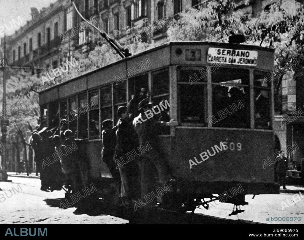 Photograph showing an overcrowded tram during rush hour in Madrid. Dated 20th Century.