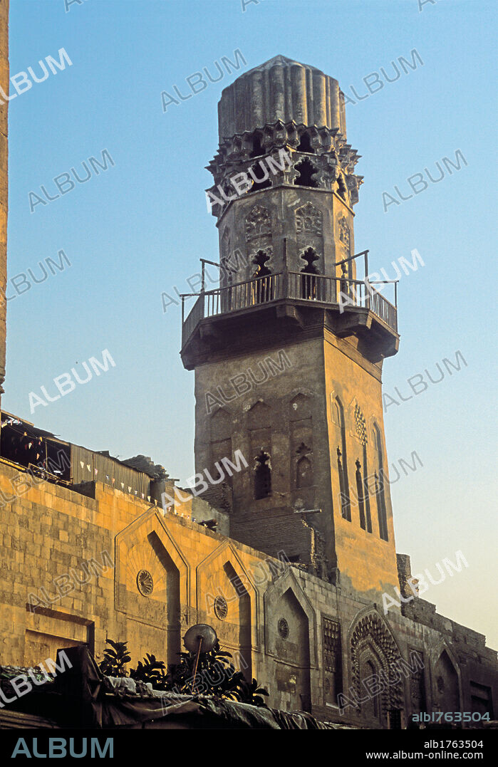 Madrasa or Madrasah or Madrassa of al Salih Najm al Din Ayyub, by Unknown Artist, 1243, 13th Century,. Egypt, El Cairo, Cairo, Cairo, MadrasaMadrasahMadrassa of al-Salih Najm al Din-Ayyub. View of the minaret of the madrasa madrasah madrassa of al Salih Najm al Din Ayyub. Traces of hull shaped arch panels decorated with deeply carved flutes, remain in the lower part of the minaret body shaft. In the upper octagonal part, a register of graceful lobe shaped openings is crowned by finely made muqarnas, on which the sturdy ribbed top of the structure is laid. 2009 photograph.