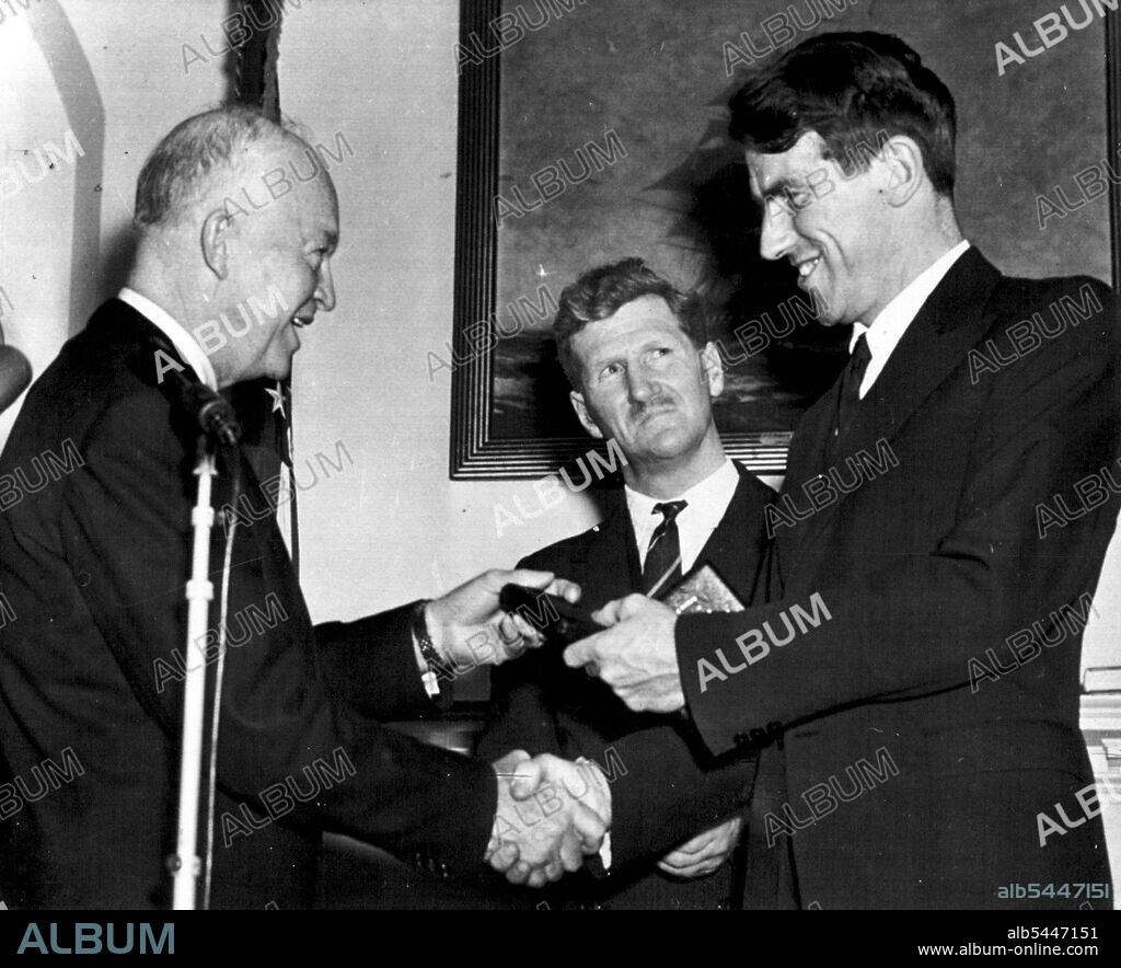 President Honors Mountain Climbers -- President Eisenhower congratulates Sir Edmund Hillary as he hands him the National Geographic Society's Hubbard medal for the climb to the top of Mt. Everest made by a British party. Sir John Hunt, center, was similarly honored during the White House ceremony today. February 11, 1954. (Photo by AP Wirephoto).