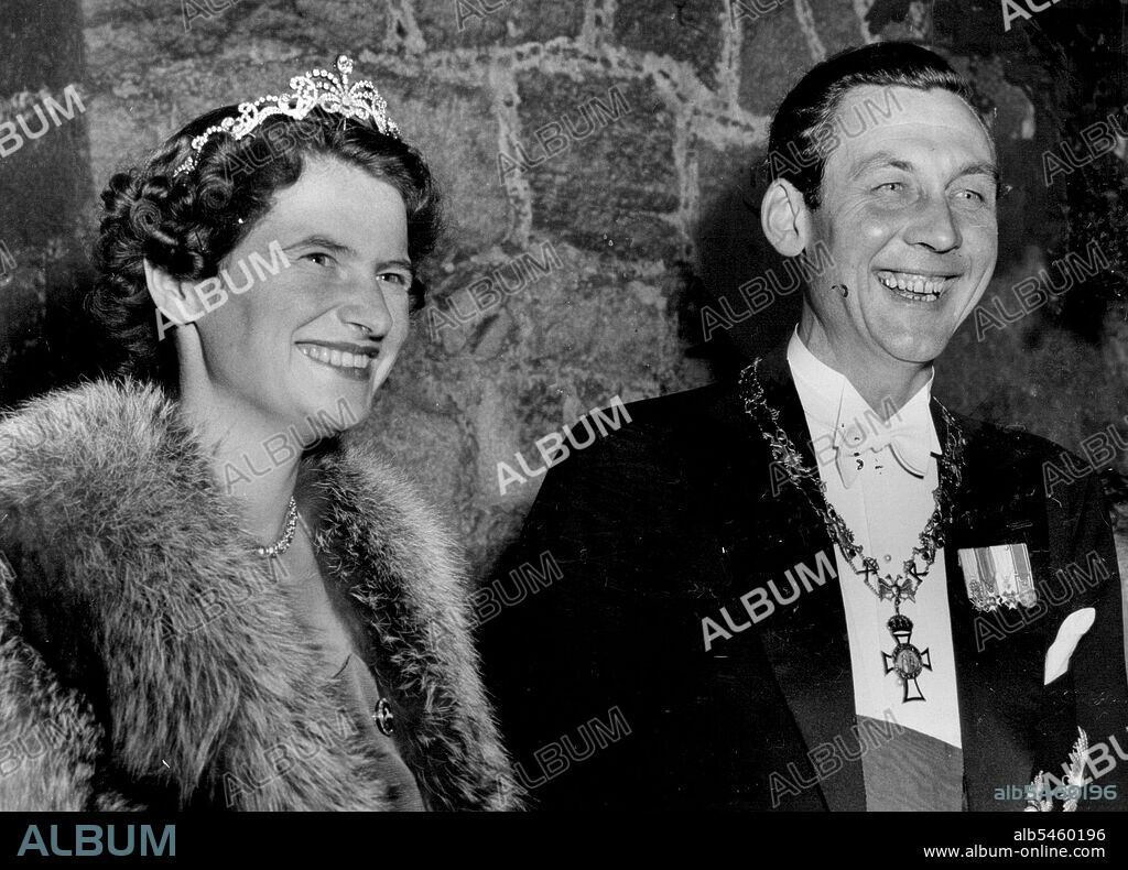 Royal Couple See Torchlight Parade - Prince Ernst August Von Hanover and his bride, Princess Ortrud Zu Schleswig-Holstein Sonderburg Gluecksburg, stand in the gates of Marienburg castle, when some 4,000 well-wishers staged a torchlight parade in their honor on the eve of their church wedding in Hanover.The couple were last week married in a civil ceremony at the Castle. September 5, 1951.