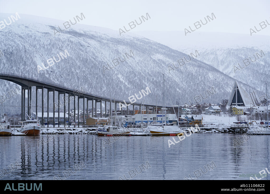 Tromso Harbour, the Bruvegen Bridge and Tromsdalen Church (Arctic Cathedral), Tromso, Troms County, Norway, Scandinavia, Europe.
