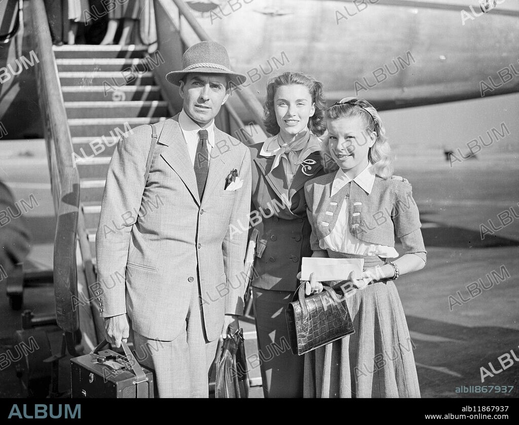 BACK FROM MOROCCO. Tyrone Power and his wife ( Linda Christian ) and Cecil Aubrey , 17-year-old French discovery , were in a party of artists and technicians who arrived at London Airport in chartered Skymaster aircraft on their return from Morocco , where they have been on location for the 20th Century Fox Film ' The Black Rose ' . The party , comprising 75 persons with £200,000 with of equipment , was the biggest ever sent on location from Brittain . Apart from making scenes for the film , which is about a 13th century English adventurer , the party had unscripted adventures of their own . They were marooned 200 miles from their Casablanca base by the Moroccan floods , and half their camp ay Ovsazarte was washed away . PICTURE SHOWS:- A actor TYRONE POWER ( left ) and his wife ( LINDA CHRISTIAN ) and CECILE AUBRY , the French discovery , on arrival at London Airport . Cecile Aubry was discovered by radio actor Ben Lyon while she was making her first film . 21 June 1949.