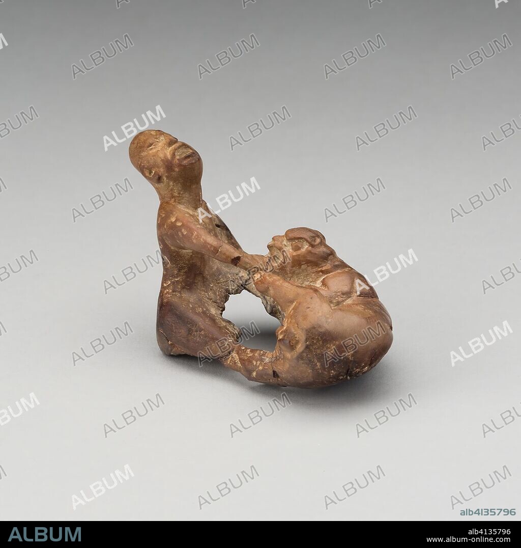 Figure of a Jaguar Attacking a Man. Maya; Possibly Tabasco, Mexico. Date: 250 AD-900 AD. Dimensions: 4.5 x 7 cm (1 3/4 x 2 3/4 in.). Wood. Origin: Mexico.