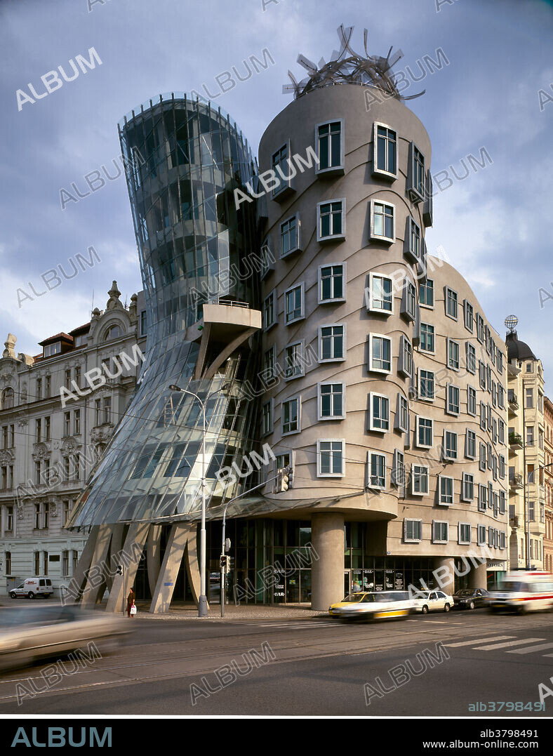 Nationale-Nederlanden Building,known as the Fred & Ginger or dancing building. A collaboration between California architect Frank Gehry,and the Studio Viado Milunic. Built 1992-96,the building gained its nicknames because of the strong body language of the implied towers. The pinched waist of the structure allowed neighbors river views to remain. A controversial structure!.