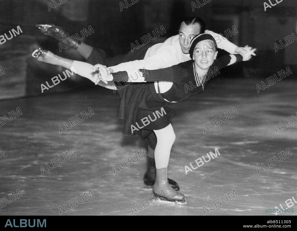 Orig. bildtext... GERMAN ICE SKATERS IN LONDON. Ernst Baier, the German amateur ice skating champion and 13-year old Fraulein Maxi Herber are now in London to take part in the Zuyder Zee Charity Carnival at the London Ice Rink this week. O.P.S. Fraulein Maxi Herber practising with her partner Herr Ernst Baier, at the London Ice Rink this morning. Anm. M Herber, 1920-2006, tysk konståkare, vann guld tillsammans med E Baier i OS i Berlin 1936. Efter karriären gifte sig paret 1940. E Baier, 1905-2001, tysk konståkare Konståkning Paråkning Balans CD416 persons: ERNST BAIER;MAXI HERBER sites: LONDON;STORBRITANNIEN;TYSKLAND*.
