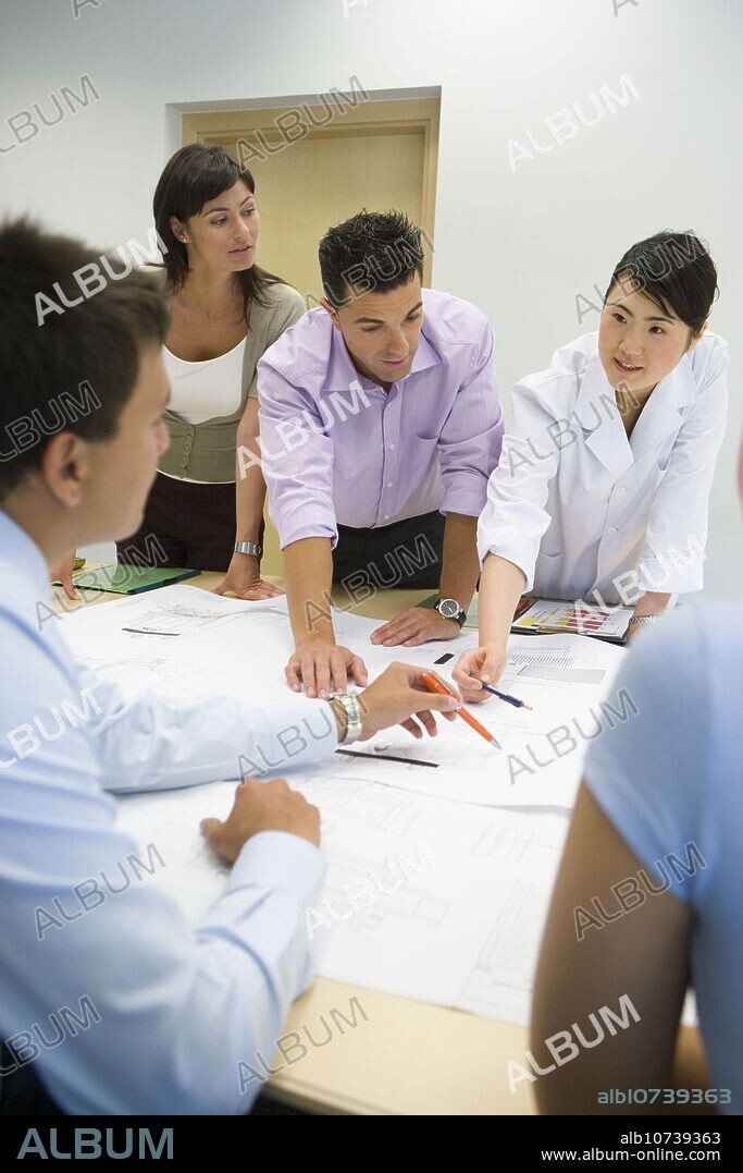Fatronik Research Centre, San Sebastian Technological Park, Donostia, Gipuzkoa, Basque Country. Fatronik Research Centre, San Sebastian Technological Park, Donostia, Gipuzkoa, Basque Country. Businesspeople and technicians looking at blueprints.