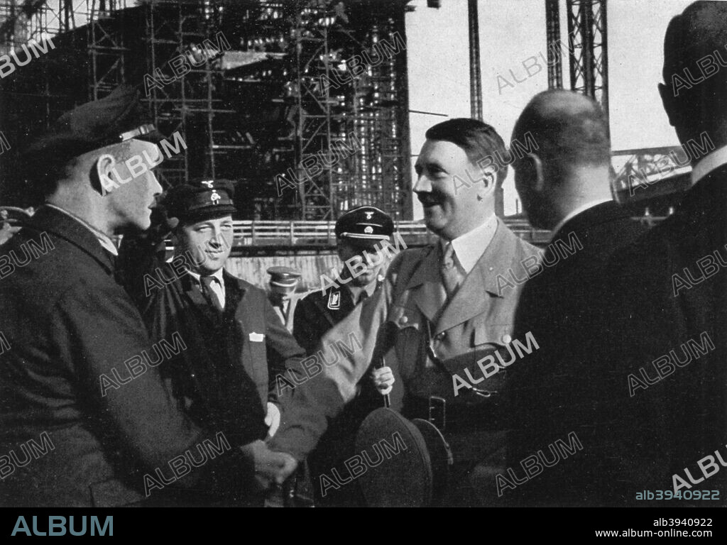 Adolf Hitler meeting the workers of the Blohm & Voss shipyard, Hamburg, Germany, 1934. Hitler (1889-1945) shaking hands with a member of the workforce. A print from Adolf Hitler. Bilder aus dem Leben des Führers, Hamburg: Cigaretten/Bilderdienst Hamburg/Bahrenfeld, 1936.