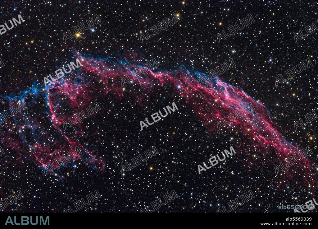 The Veil Nebula, also known as the Cygnus Loop or the Witch's Broom Nebula, is a large, relatively faint supernova remnant in the constellation Cygnus. When finely resolved, some parts of the image appear to be rope like filaments. The standard explanation is that the shock waves are so thin, less than one part in 50,000 of the radius, that the shell is only visible when viewed exactly edge-on, giving the shell the appearance of a filament. Undulations in the surface of the shell lead to multiple filamentary images, which appear to be intertwined.