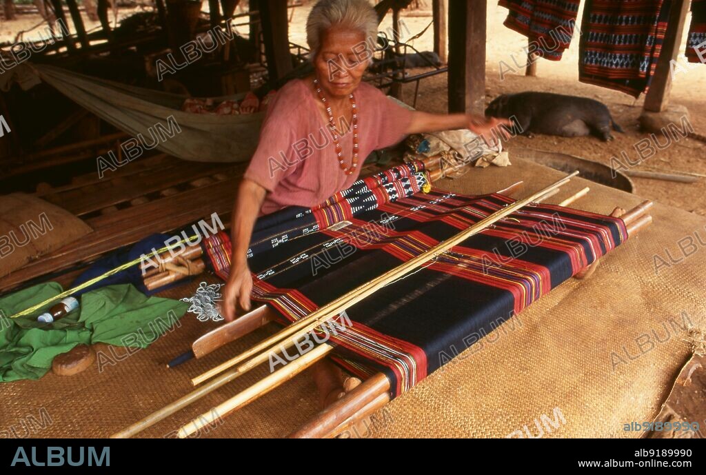 Laos: Brao weaver with foot loom, Bolaven Plateau, Champasak Province. The Brao people are an ethnic group that live on both sides of the Cambodia-Laos border. There are approximately 60,000 Brao people, broadly defined, worldwide. They mainly live in Attapeu and Champasak Provinces in southern Laos, and Ratanakiri and Stung Treng Provinces in northeastern Cambodia.