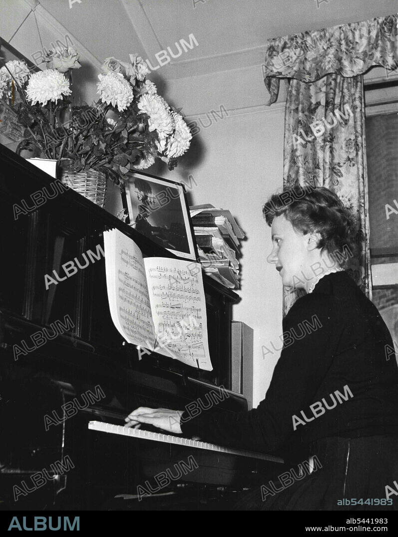With a Photograph of Sir Malcolm Sargent to encourage her, Dorothy practices hours each day, receives frequent complaints from neighbors about making too much noise. A piano for £10, a photo of Sir Malcolm for inspiration a mews flat for style - and you're going places in London. December 16, 1955. (Photo by A.G.S.U.P Picture).