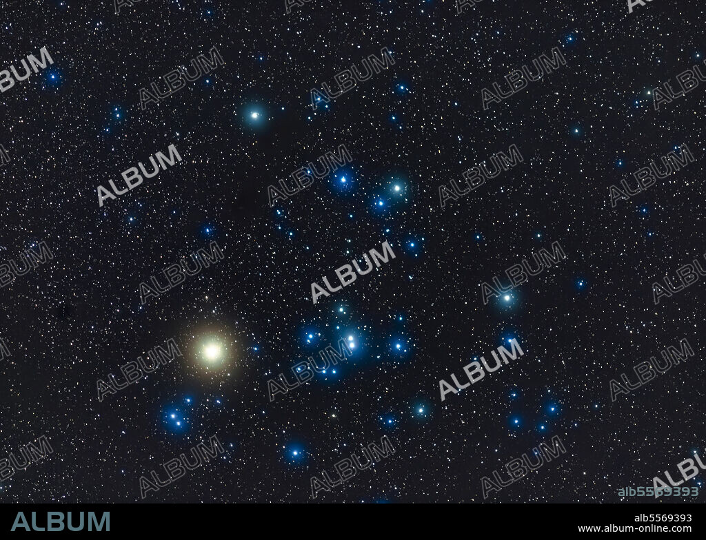 The Hyades star cluster with the red giant star Aldebaran (looking yellow here) in Taurus the bull in the winter sky.