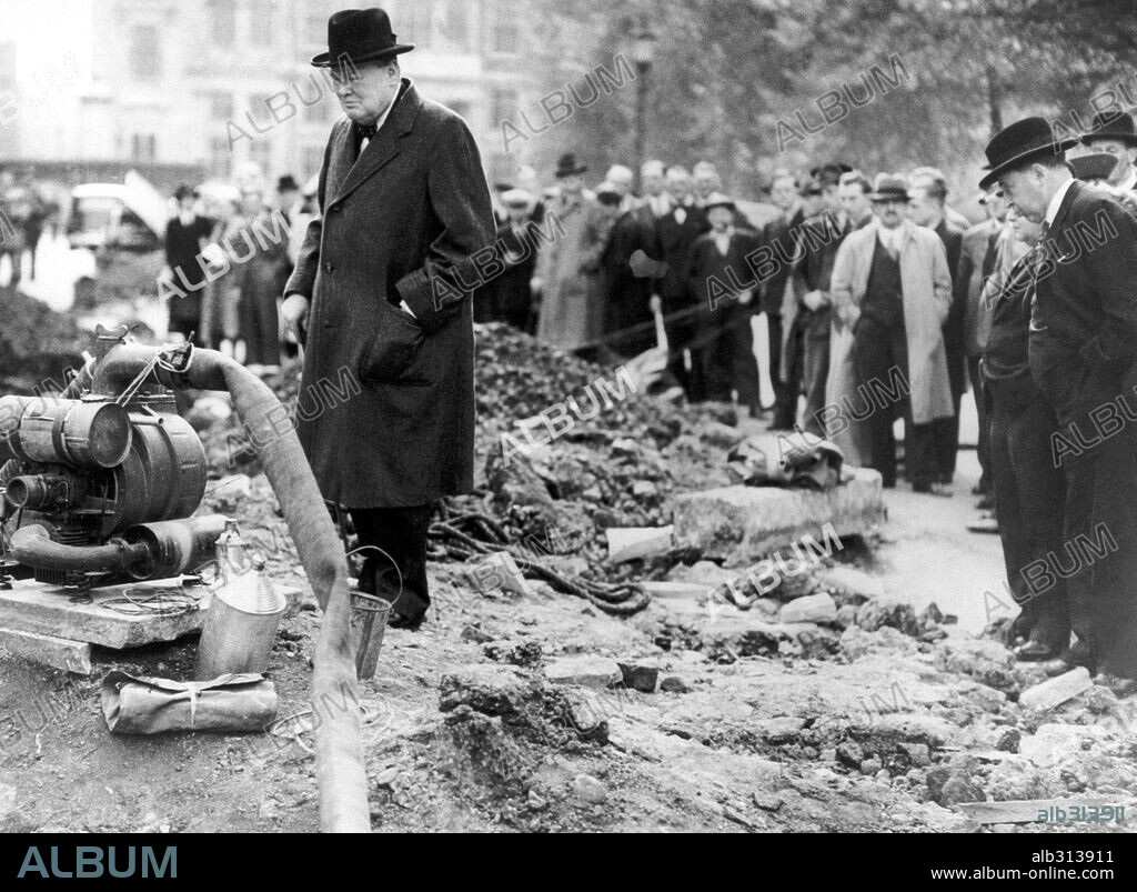The Prime Minister Mr. Winston Churchill (left) and Home Secretary and Minister for Home Security, Sir John Anderson (extreme right), inspecting a London bomb crater. New York Times Photograph. 30/9/40.
