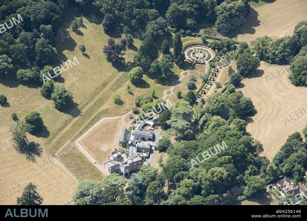 Luscombe Castle, Dawlish, Devon, 2018. Aerial view showing the house and part of the parkland and formal garden. The house was designed in the late 1790s by John Nash in the style of a picturesque castle. The park was laid out to designs by Humphry Repton.